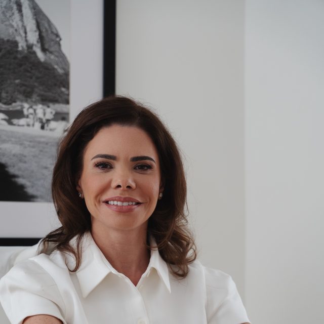 Dr. Lionella Moraes smiling at her consultation desk